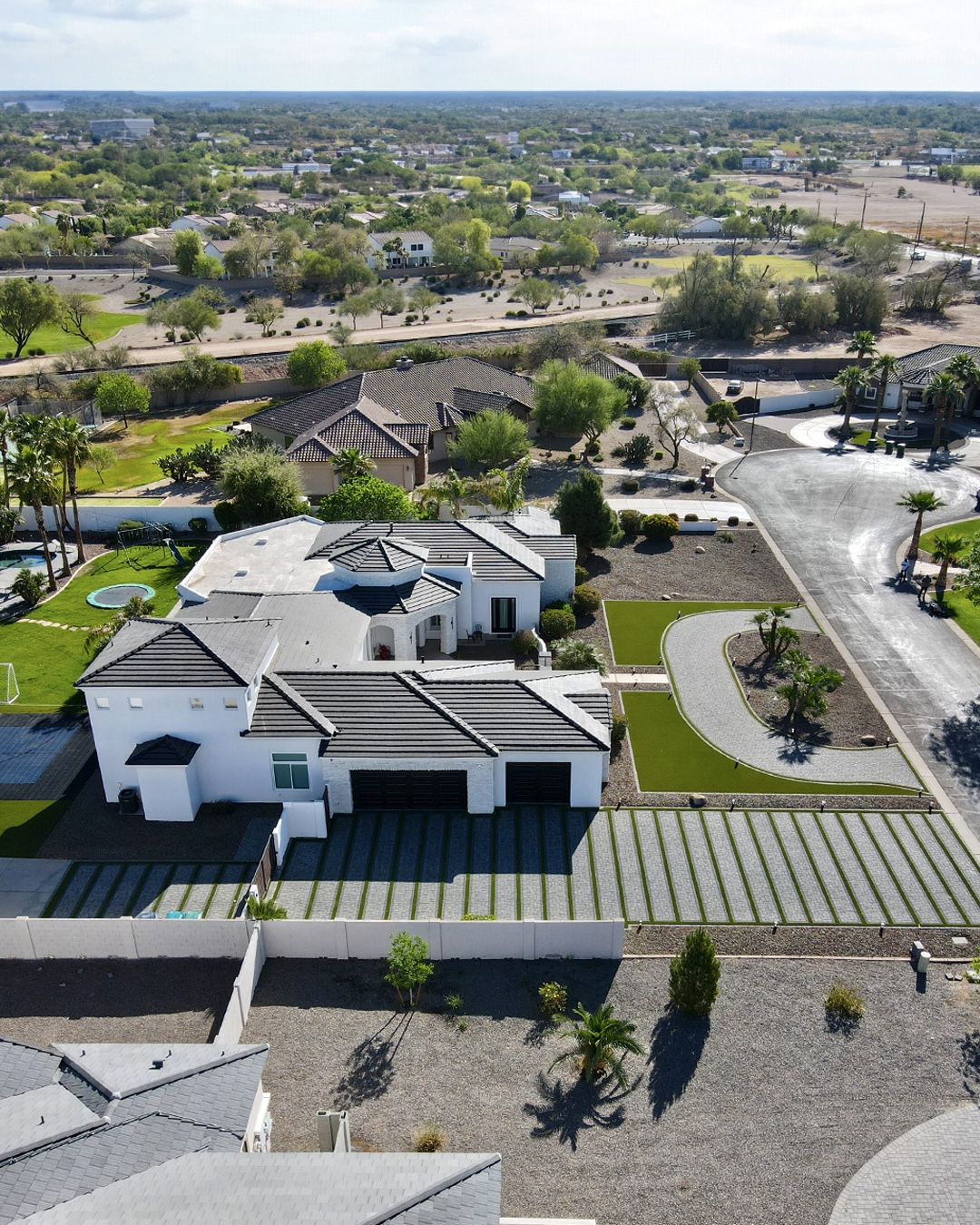 Wide aerial view of the estate property and surrounding neighborhood