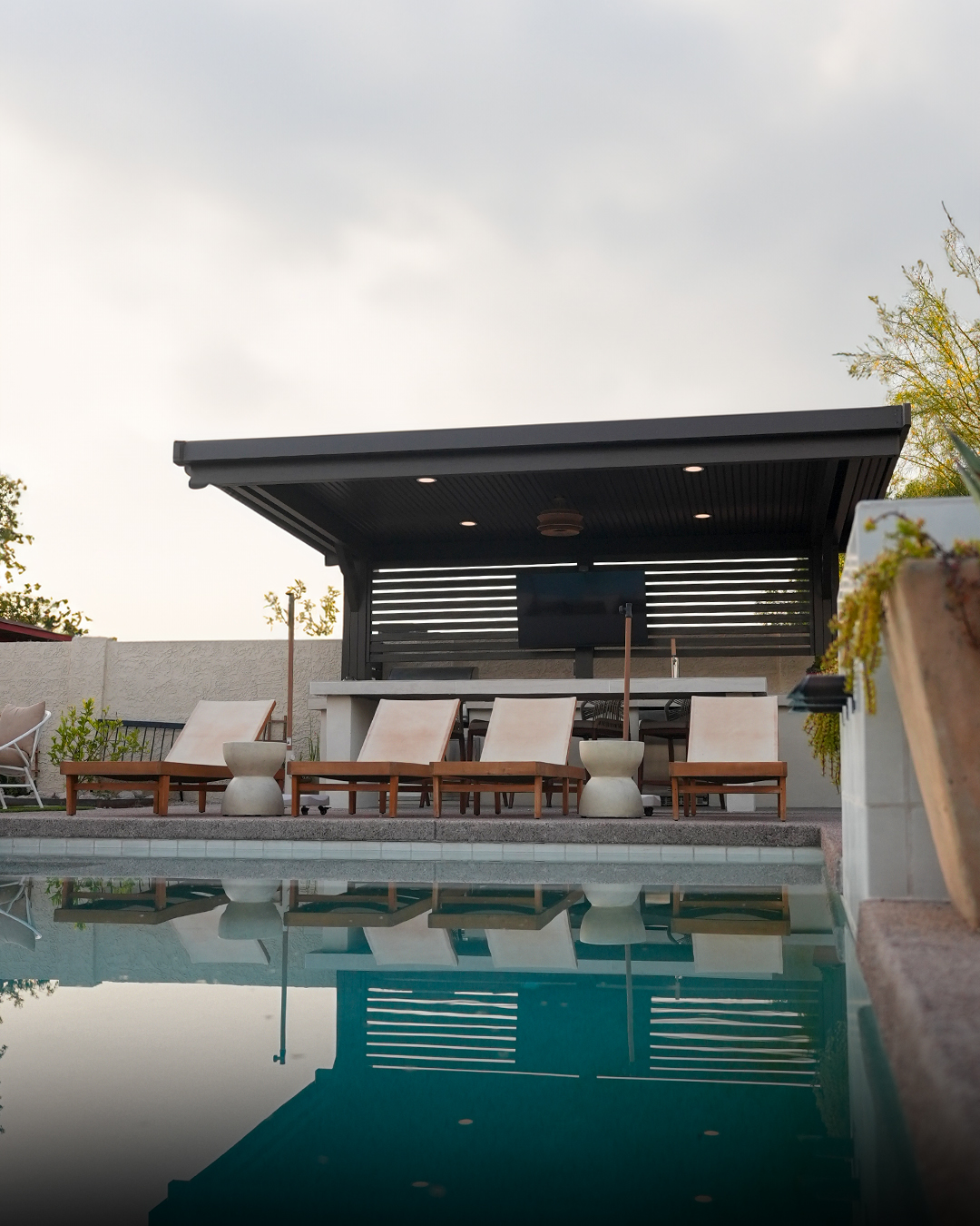 Cabana reflected in a swimming pool at twilight