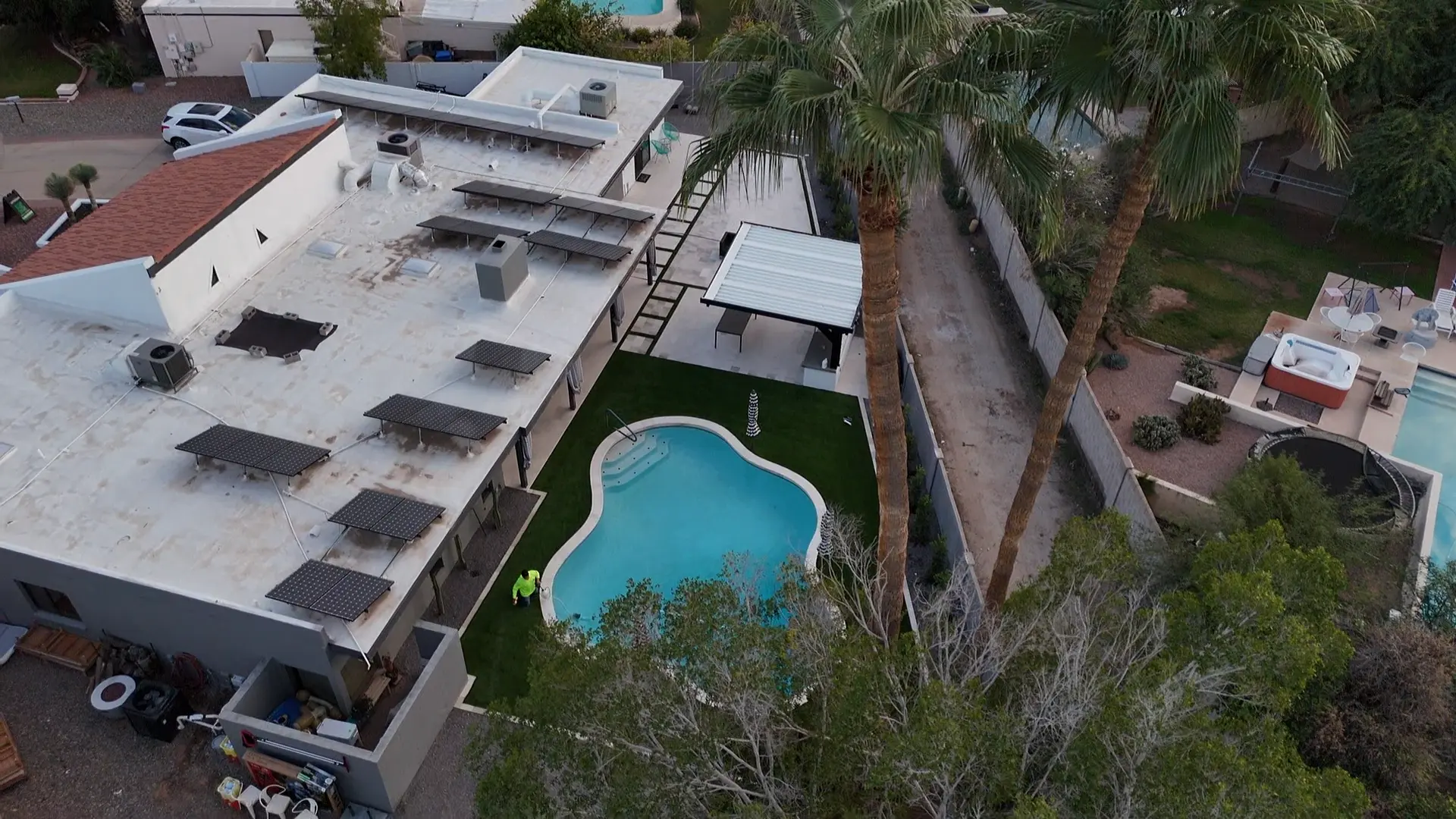Aerial view of a Phoenix backyard with pool, turf lawn and cabana