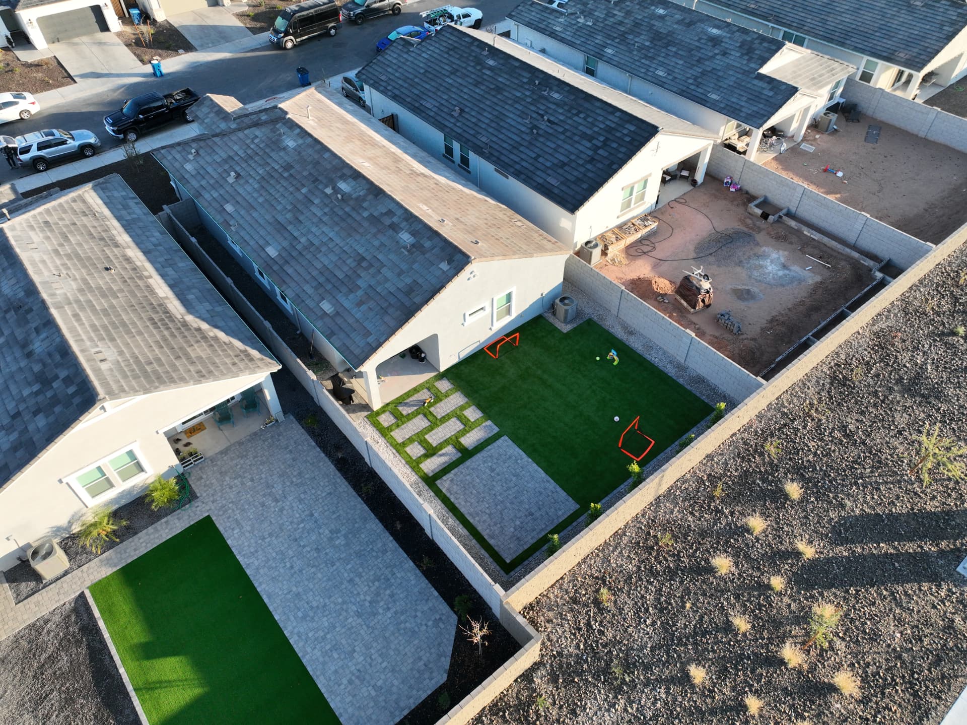 Aerial view of a backyard with paver patio, turf lawn and paver inlay grid