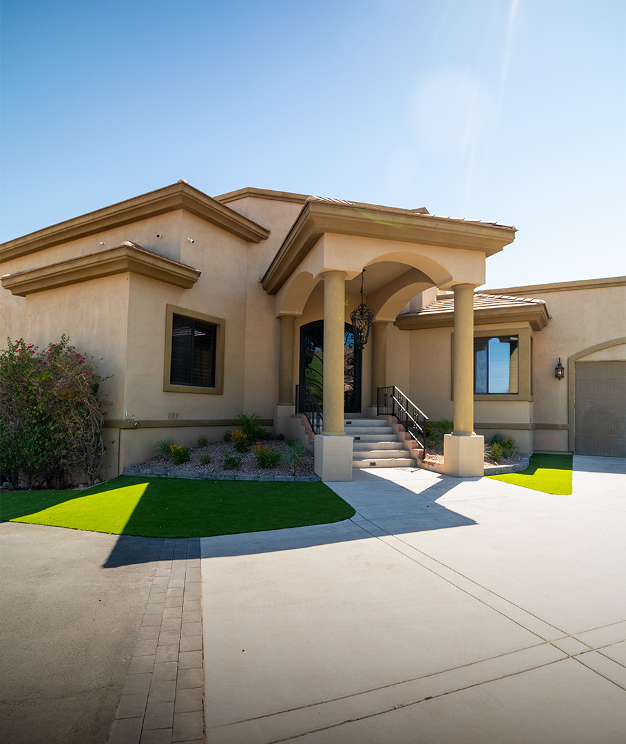 Home entry with manicured turf panels and desert planting beds